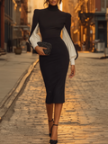 Elegante vestido midi negro con mangas blancas voluminosas